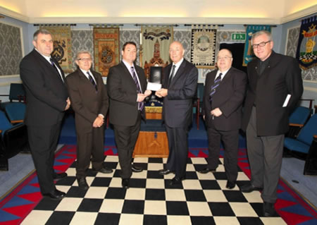  Andy Thomson, Chris Cory, Chris Curry, receiving the cheque from RW Bro Max Bayes, PGM, David Leveridge and Jonathan George representing Wellingborough Bowling Club and Bonkers Band (by courtesy of the Northamptonshire Telegraph)