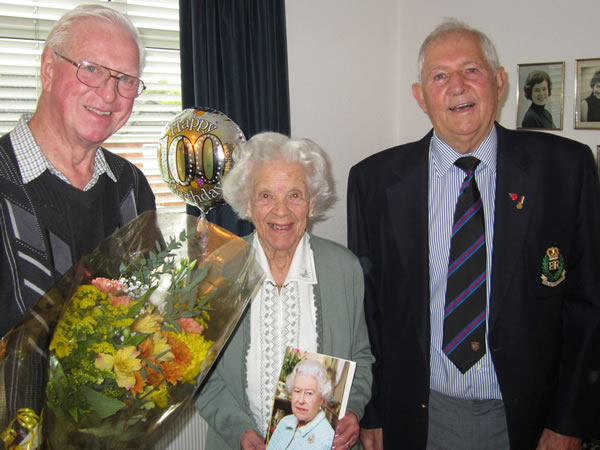 WBro Geoff Smith, WM of Risdene Lodge, presents a bouquet of flowers to Mrs Harris, who is holding her card from the Queen - also in the picture is WBro Peter Childs, Almoner