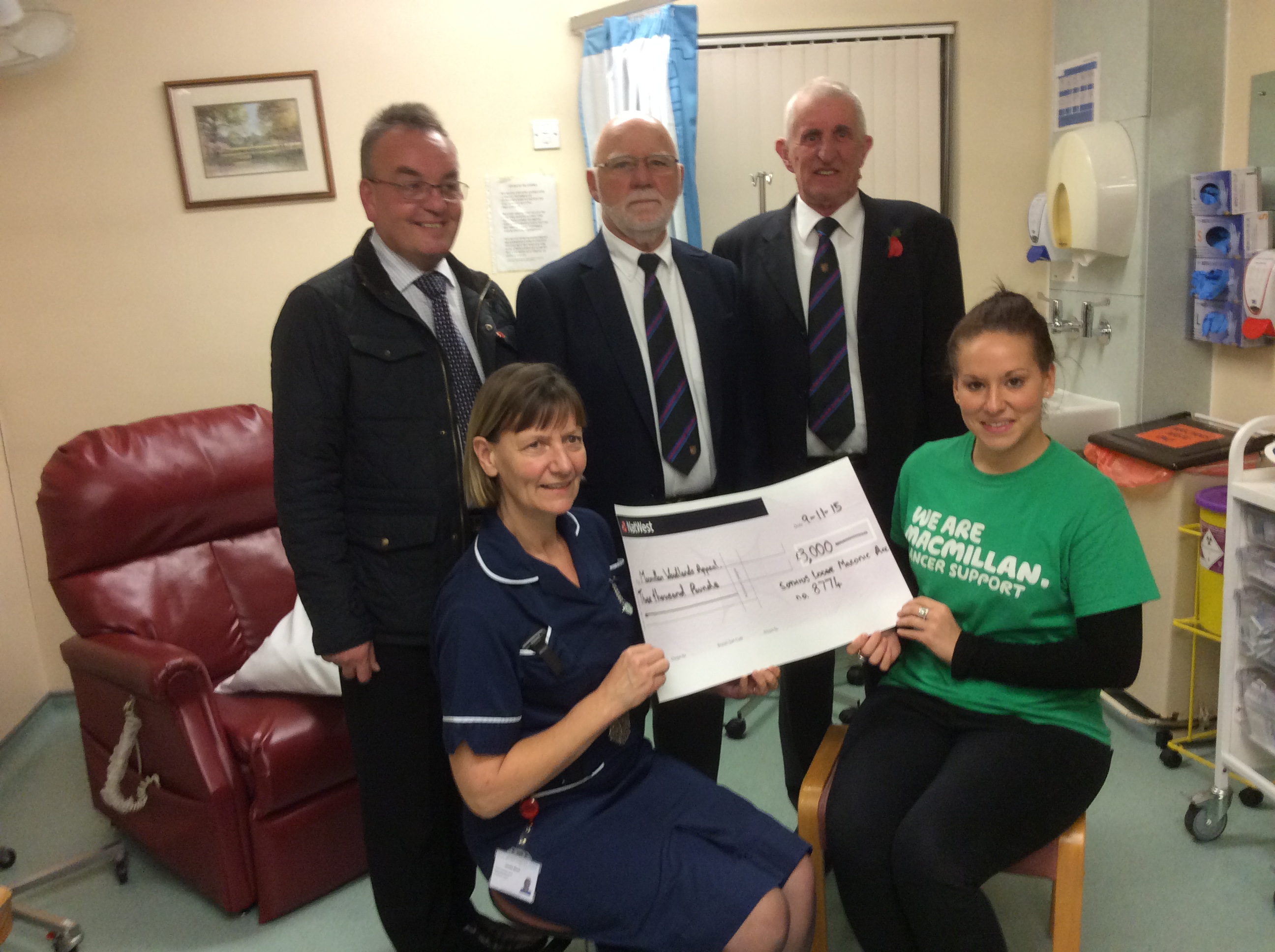 Bro Mark Bramley, W.Bro Joe Batten, W.Bro John Dench along with Senior nurse Janette Birch and Jessica Levin, fund rasing Manager for Macillan nurses