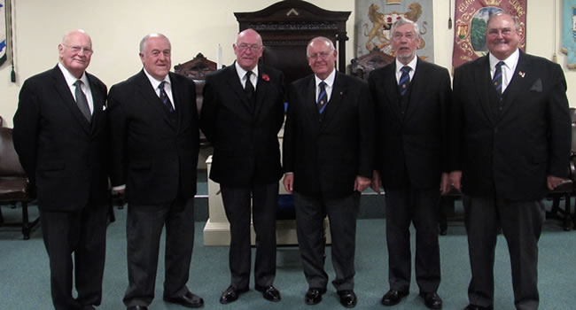 PGM, RWBro Max Bayes (centre left) with newly installed WM, VWBro Richard Davis (centre right) & Wardens & Deacons